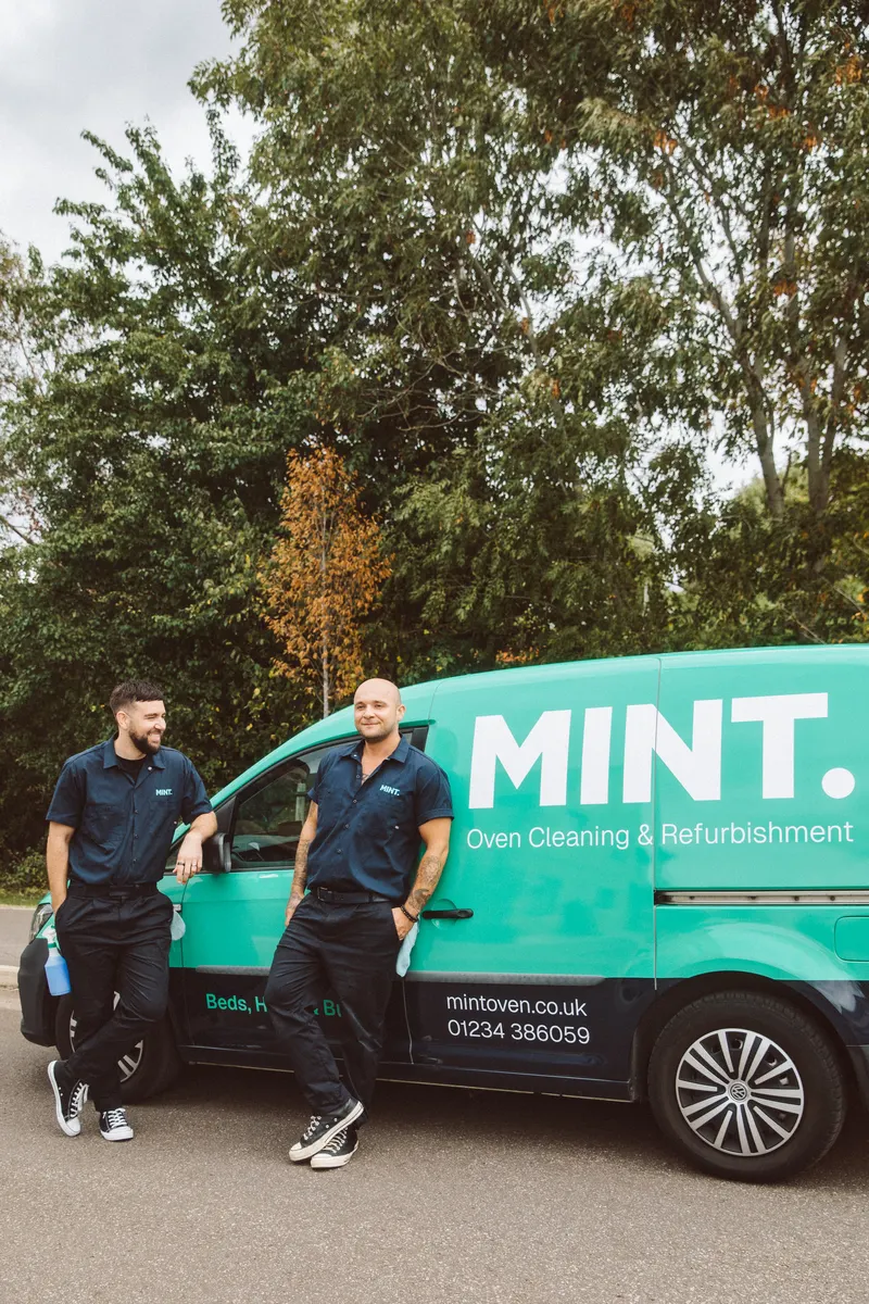 Sam, left, and Taylor, right, standing beside the MINT van