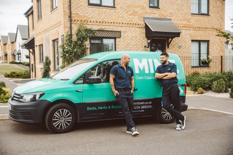 Taylor and his teammate beside the MINT van