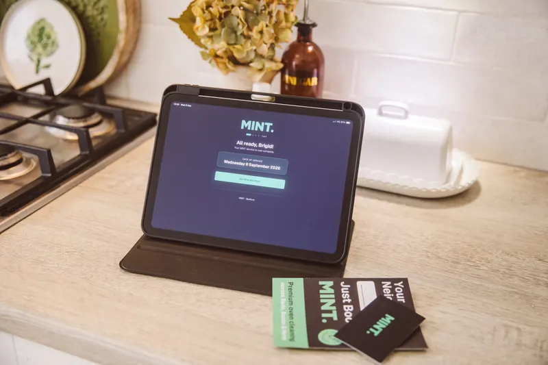 An iPad and MINT branded cards on a kitchen worktop