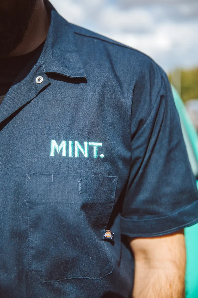 Close-up of the MINT logo on Taylor's uniform