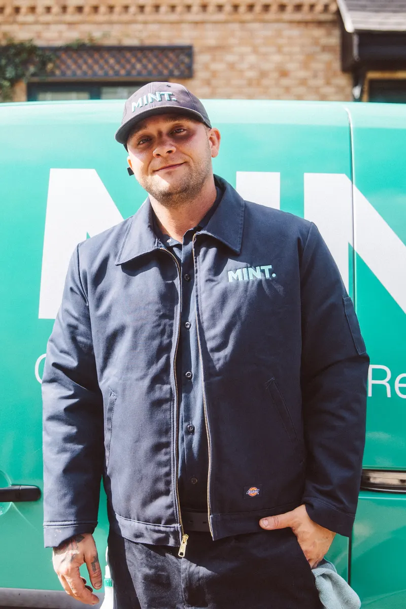 Taylor in his MINT jacket beside the van