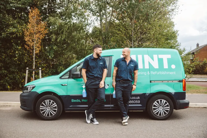 The MINT team beside the branded van