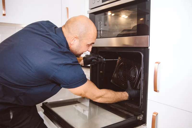 Taylor stripping down the oven to clean its interior